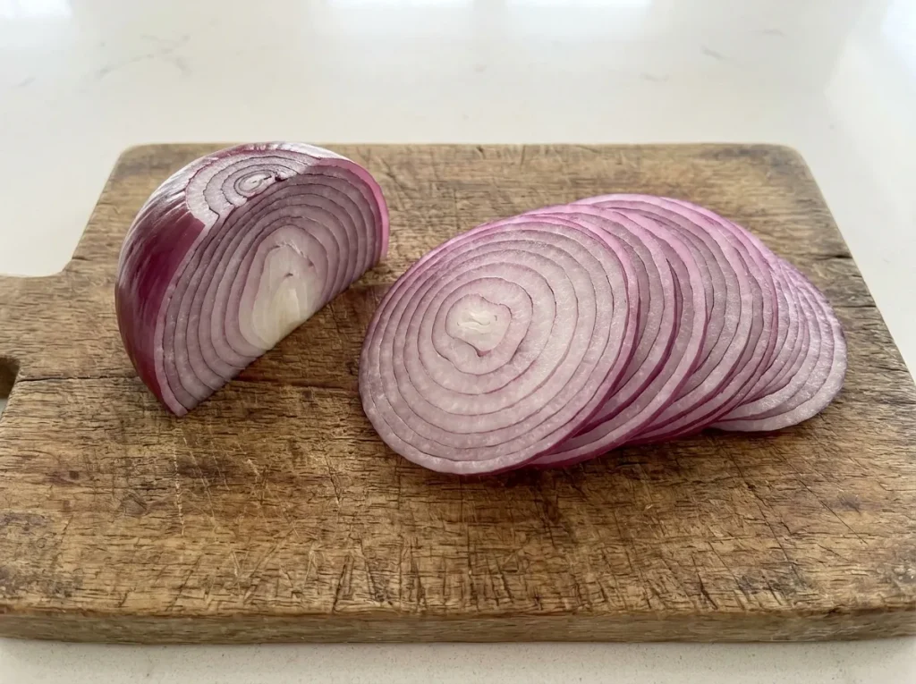 Thinly sliced red onion for bean and tuna salad